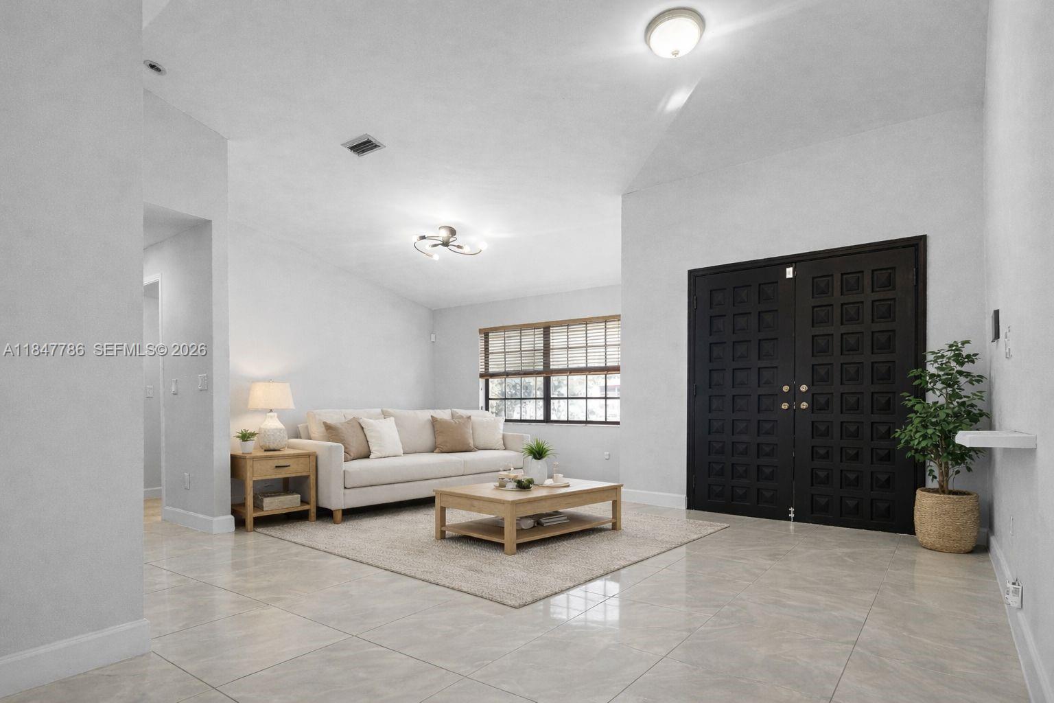13925 Southwest 26th Terrace Miami, FL 33175 - Photo 6 of 42 a living room with furniture and a potted plant