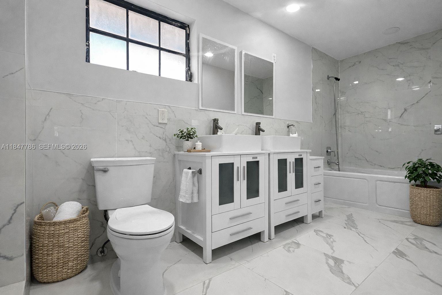 13925 Southwest 26th Terrace Miami, FL 33175 - Photo 8 of 42 a bathroom with a white tub toilet and sink
