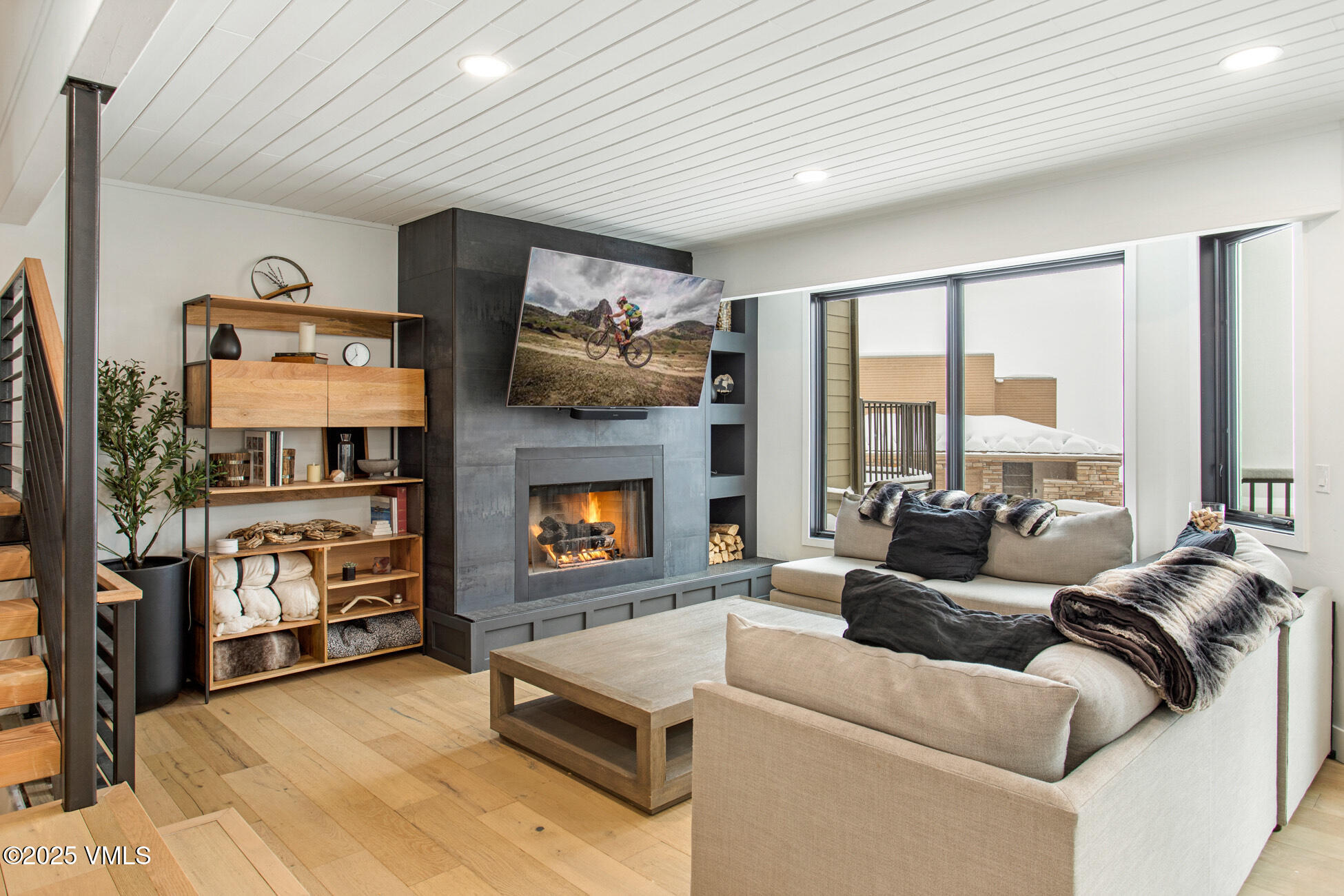 770 Potato Patch Drive, Unit H Vail, CO 81657 - Photo 2 of 6 a living room with furniture a flat screen tv and a fireplace