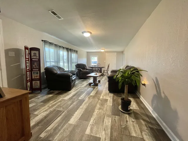 a view of a livingroom with furniture and a flat screen tv