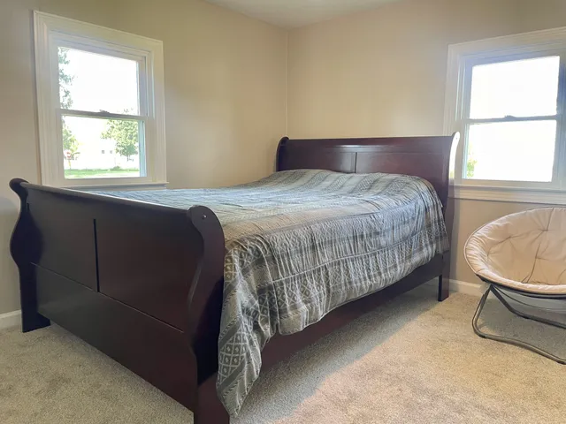 a bedroom with a bed and window