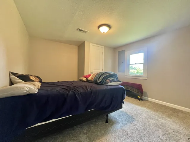a bedroom with a bed and window
