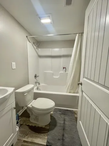 a bathroom with a toilet a sink and a bathtub