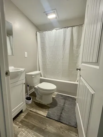 a bathroom with a toilet and a shower