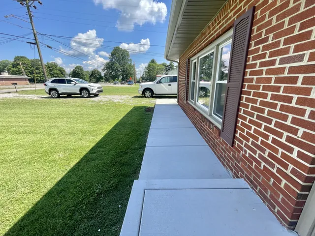 a view of a yard with cars parked