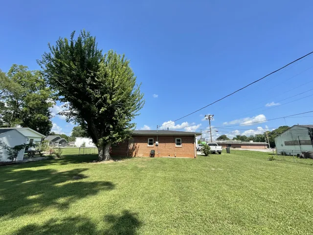 a front view of a house with a yard garage and a chair