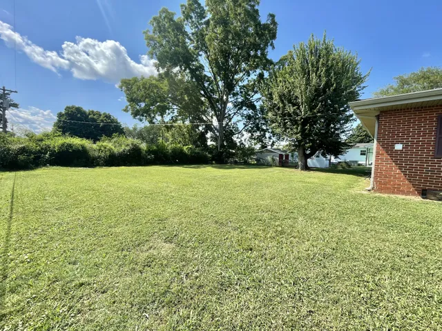 a view of a garden with a house