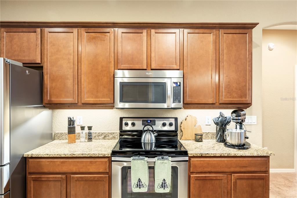2836 Whitney Street Lakeland, FL 33813 - Photo 11 of 44 a kitchen with granite countertop stainless steel appliances a sink stove and cabinets