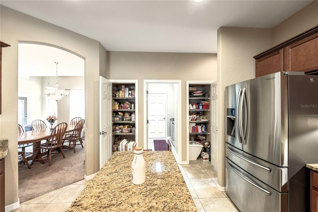 2836 Whitney Street Lakeland, FL 33813 - Photo 13 of 44 a kitchen with stainless steel appliances granite countertop a refrigerator and a sink
