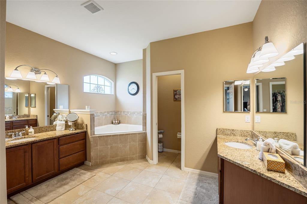 2836 Whitney Street Lakeland, FL 33813 - Photo 18 of 44 a spacious bathroom with a granite countertop sink mirror and bathtub