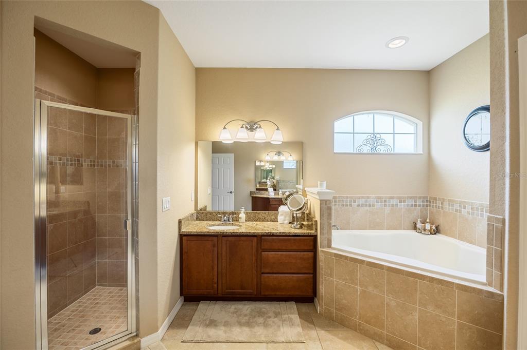 2836 Whitney Street Lakeland, FL 33813 - Photo 19 of 44 a bathroom with a tub sink shower and mirror