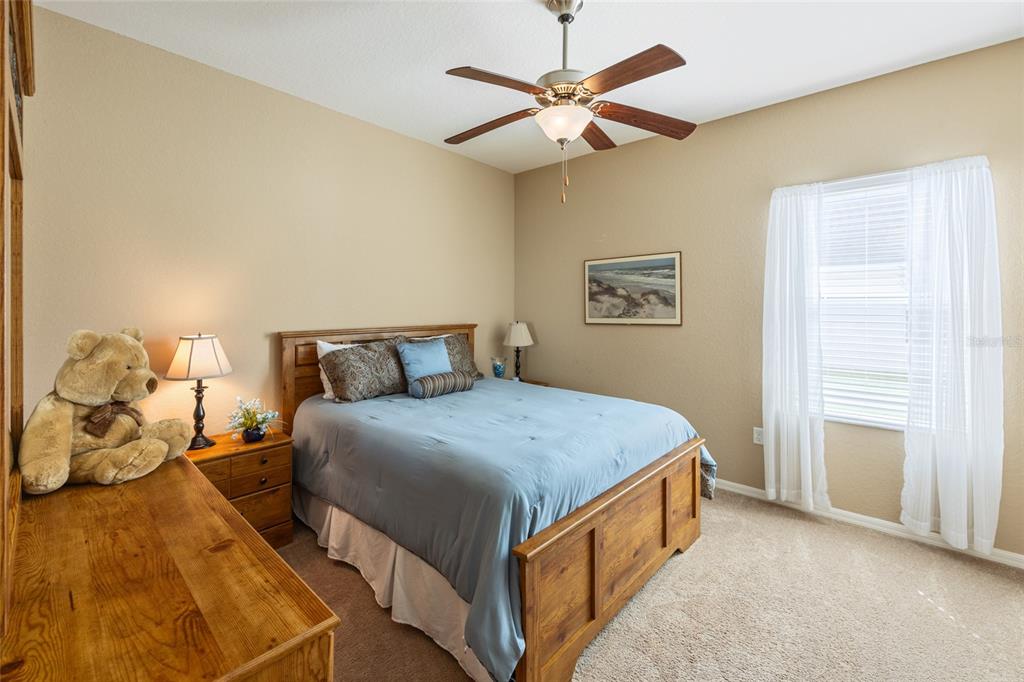 2836 Whitney Street Lakeland, FL 33813 - Photo 22 of 44 a bedroom with a bed and a chandelier