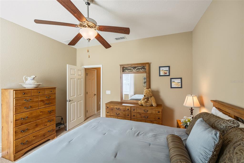 2836 Whitney Street Lakeland, FL 33813 - Photo 23 of 44 a bedroom with a bed and ceiling fan