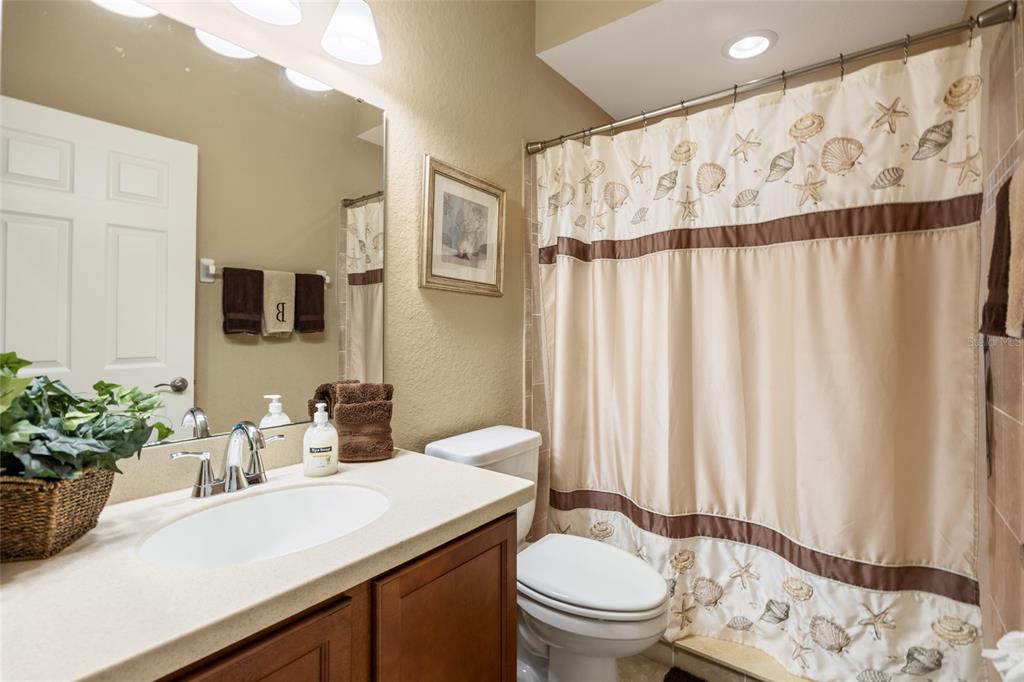 2836 Whitney Street Lakeland, FL 33813 - Photo 24 of 44 a bathroom with a sink a toilet and shower curtain