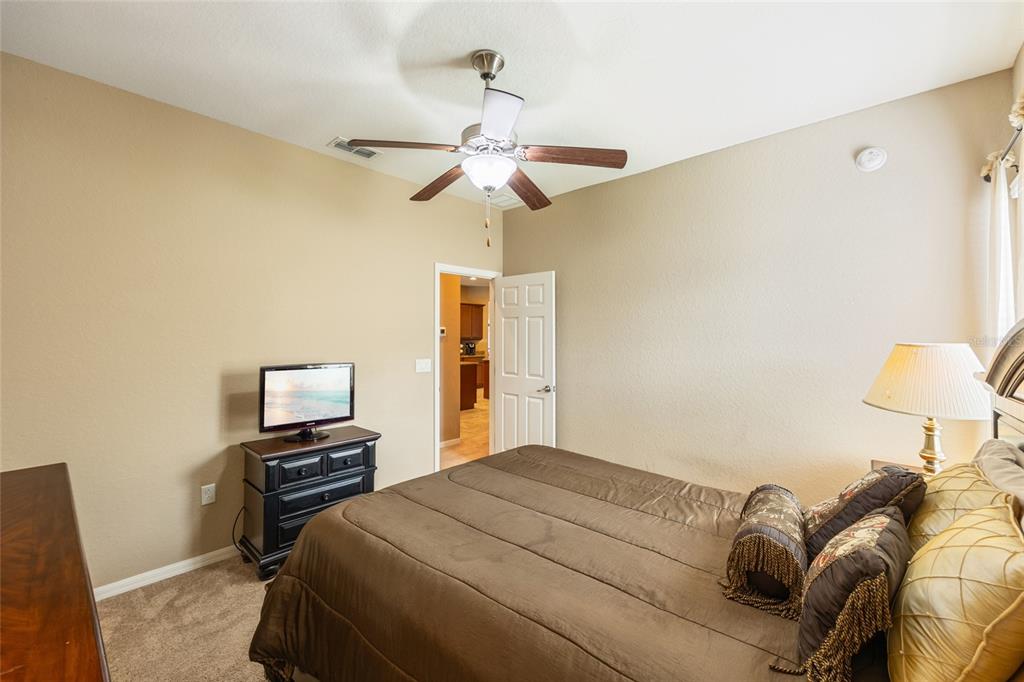 2836 Whitney Street Lakeland, FL 33813 - Photo 28 of 44 a bedroom with a bed and a chandelier