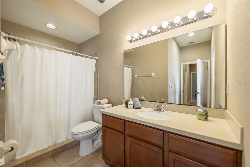 2836 Whitney Street Lakeland, FL 33813 - Photo 29 of 44 a bathroom with a double vanity sink mirror and toilet