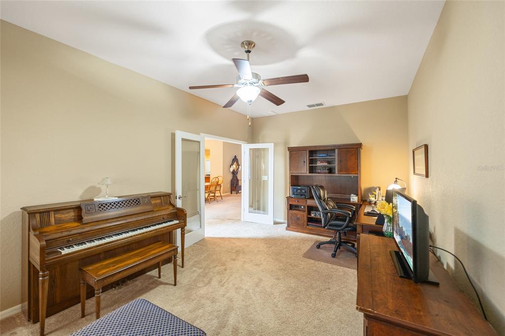 2836 Whitney Street Lakeland, FL 33813 - Photo 9 of 44 a living room with furniture a dining table and a piano