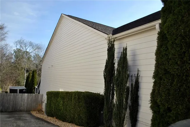 a living room with furniture kitchen view and a chandelier