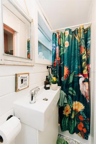 a bathroom with a sink a toilet and a mirror