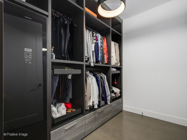 a view of walk in closet with clothes and shoes