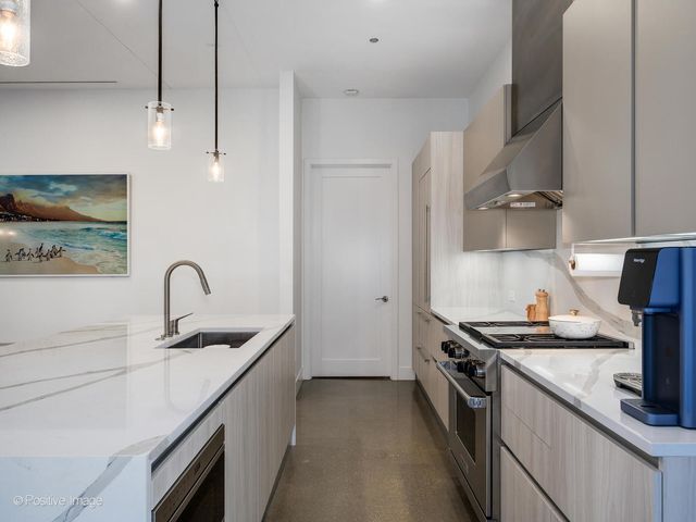 a kitchen that has a sink and a stove