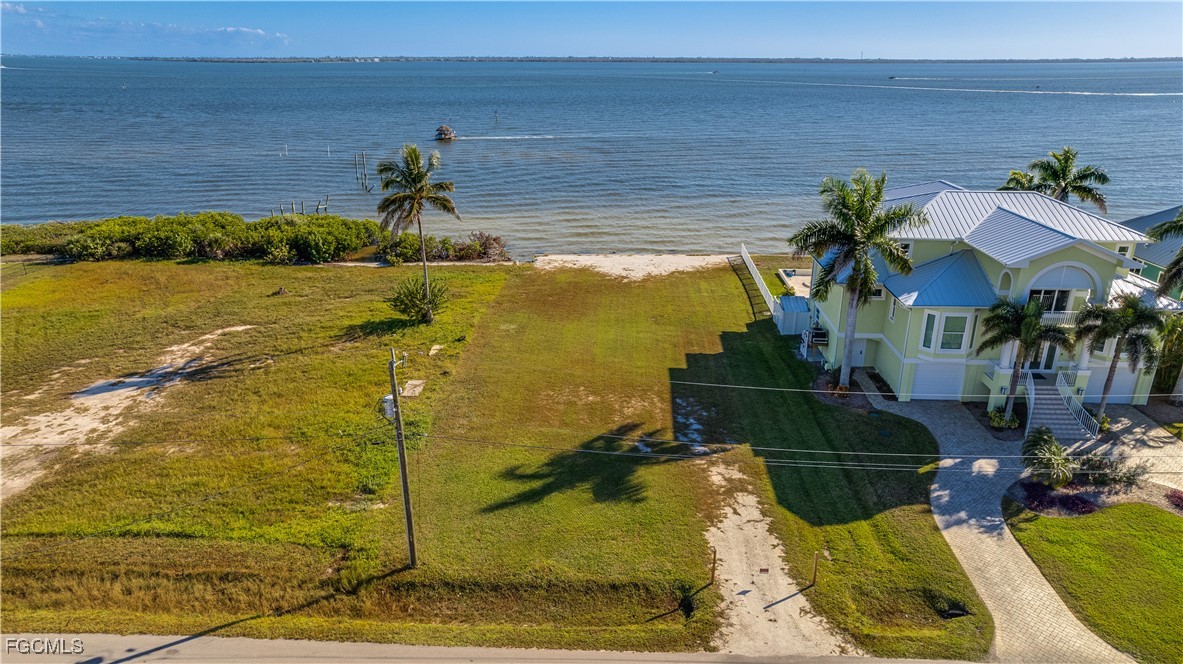 3429 First Avenue St. James City, FL 33956 - Photo 2 of 8 a view of a lake with a building in the background