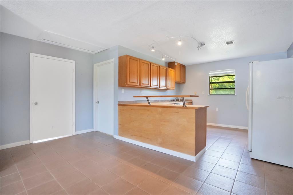 5785 Gilliam Road Orlando, FL 32818 - Photo 65 of 100 a view of kitchen with stainless steel appliances granite countertop a sink and a stove top oven
