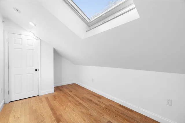 a view of a room with wooden floor