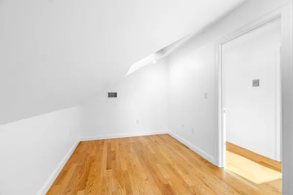 a view of a room with wooden floor