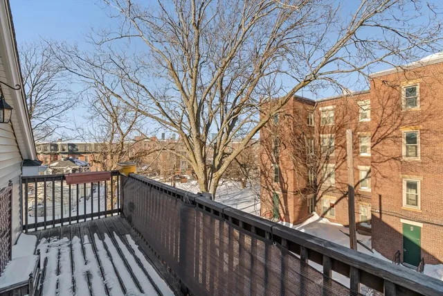 a view of a wooden bench next to a building