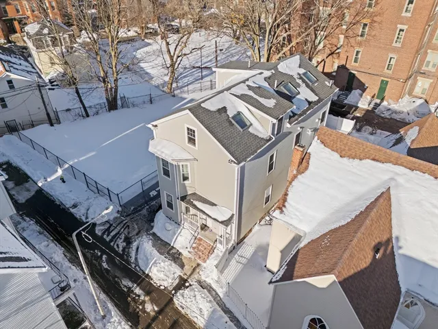 an aerial view of a house with a roof deck