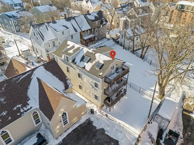 an aerial view of a building with backyard