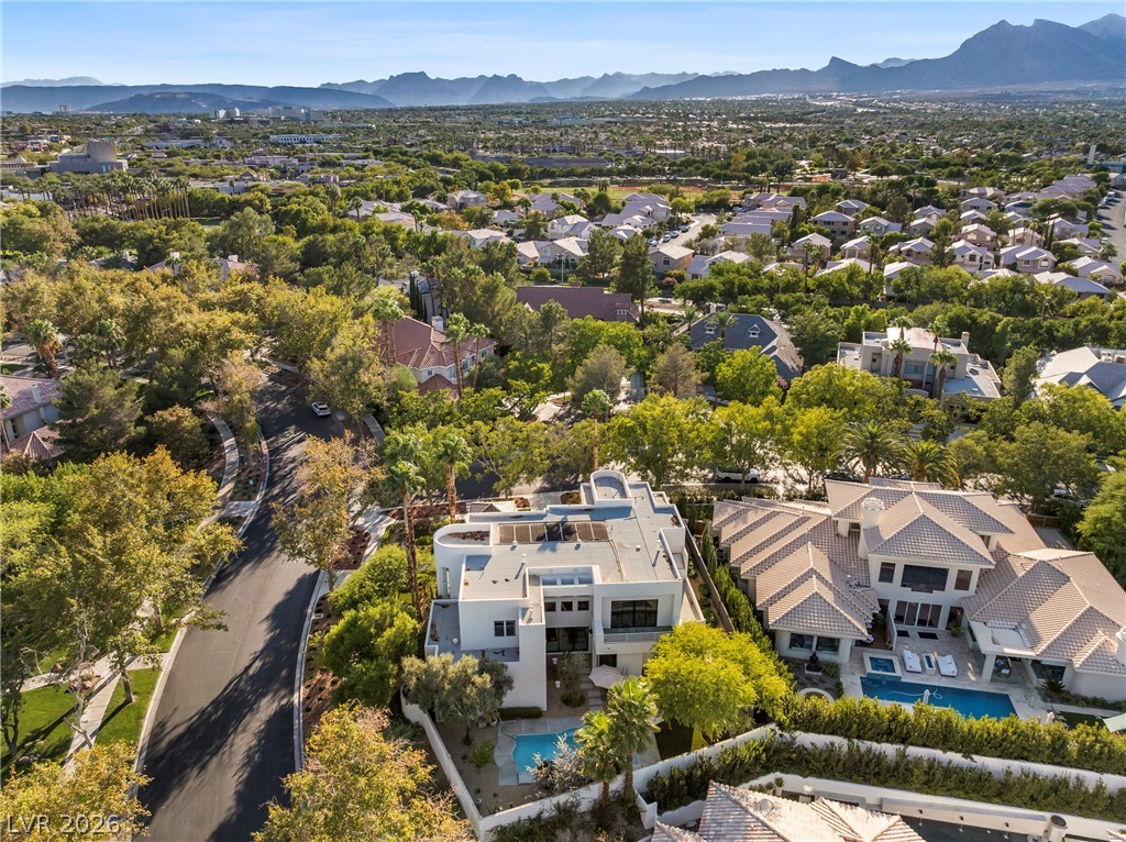 2000 Grouse Street Las Vegas, NV 89134 - Photo 87 of 89 An aerial panorama reveals a contemporary residence nestled amongst mature trees, with a refreshing pool.