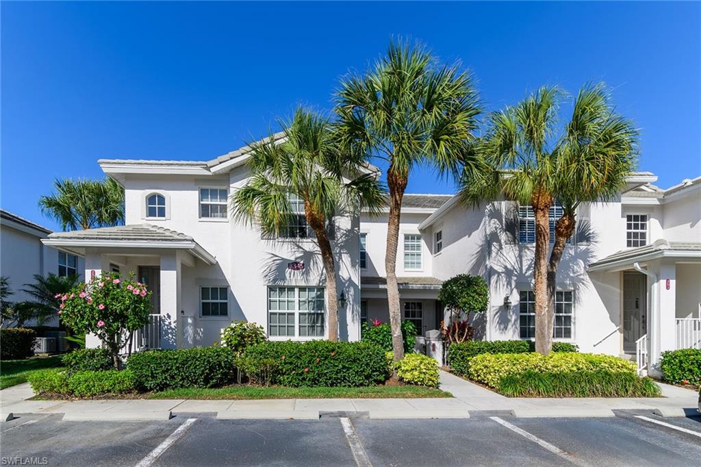8345 Whisper Trace Way, Unit 102 Naples, FL 34114 - Photo 1 of 25 front view of a house with potted plants
