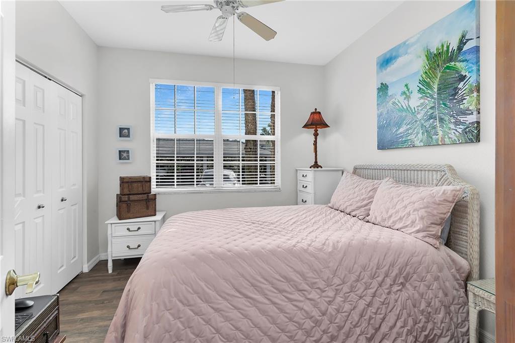 8345 Whisper Trace Way, Unit 102 Naples, FL 34114 - Photo 14 of 25 a bedroom with a large bed and a window