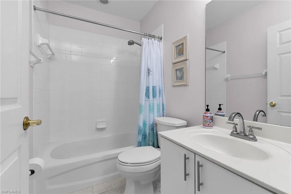 8345 Whisper Trace Way, Unit 102 Naples, FL 34114 - Photo 15 of 25 a bathroom with a sink toilet and shower
