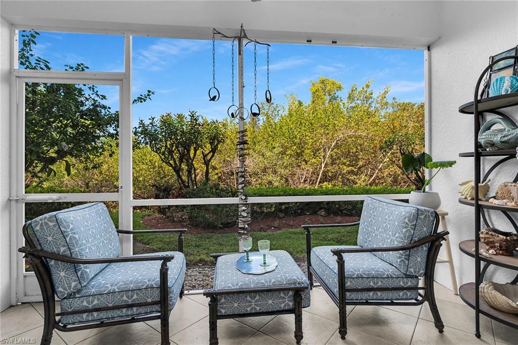 8345 Whisper Trace Way, Unit 102 Naples, FL 34114 - Photo 16 of 25 a view of a chairs and table in patio