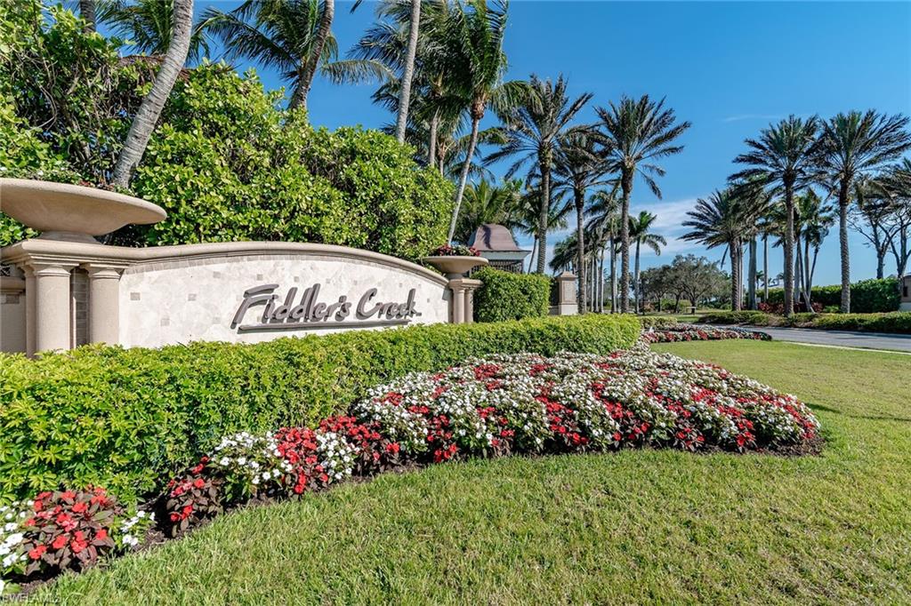 8345 Whisper Trace Way, Unit 102 Naples, FL 34114 - Photo 17 of 25 a view of a garden with flowers and trees