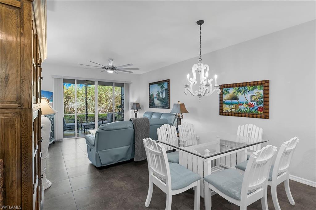 8345 Whisper Trace Way, Unit 102 Naples, FL 34114 - Photo 6 of 25 a dining room with furniture a chandelier and window