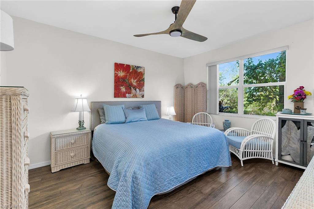 8345 Whisper Trace Way, Unit 102 Naples, FL 34114 - Photo 10 of 25 a bedroom with a bed and a large window