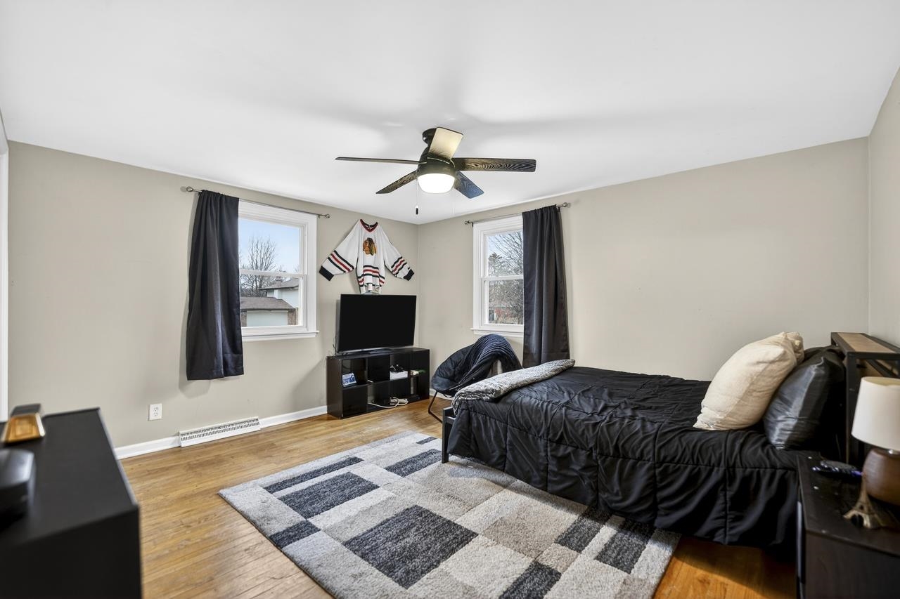 4966 Brigadoon Road Rockford, IL 61107 - Photo 22 of 40 a living room with furniture and a flat screen tv