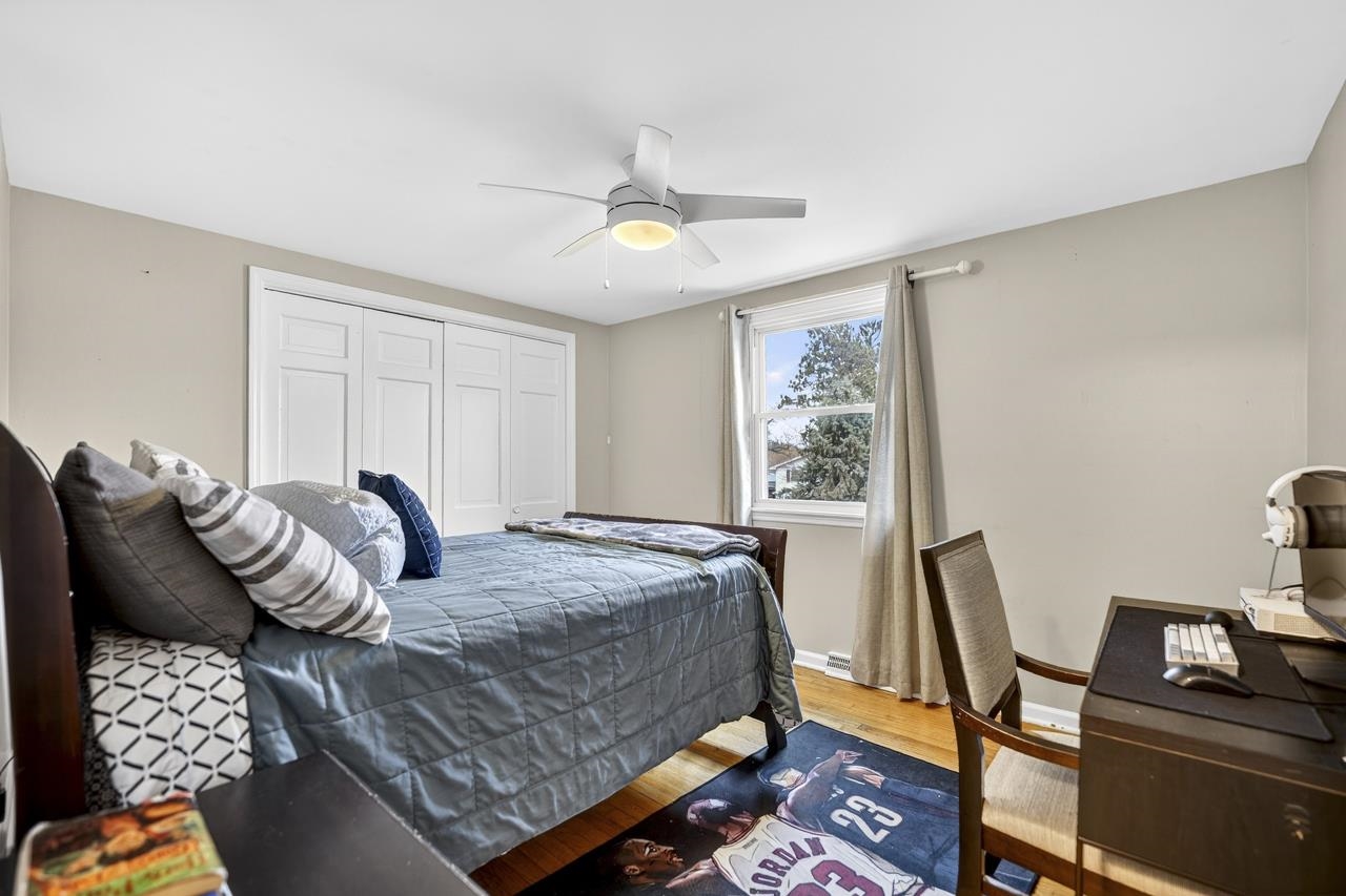 4966 Brigadoon Road Rockford, IL 61107 - Photo 24 of 40 a bedroom with a bed and wooden floor