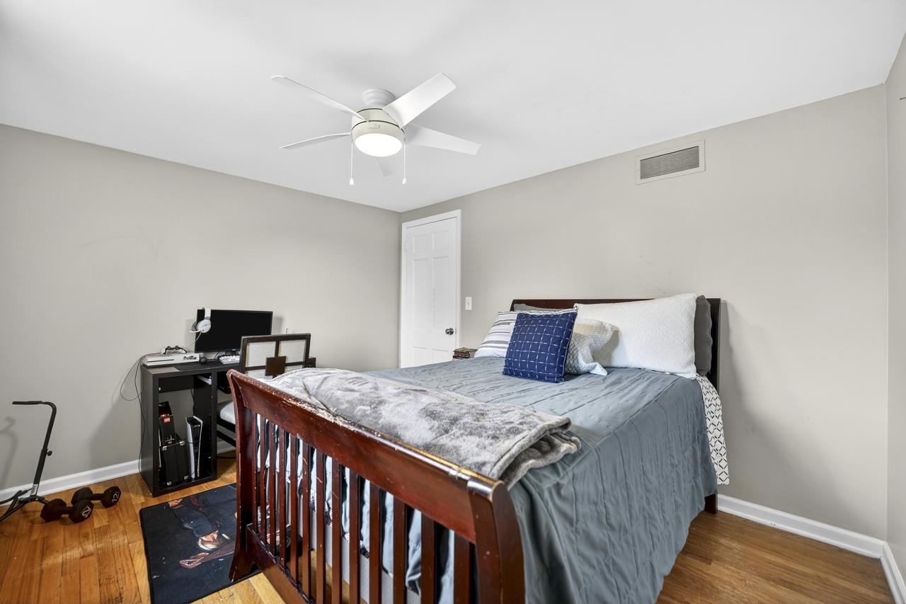 4966 Brigadoon Road Rockford, IL 61107 - Photo 25 of 40 a bedroom with a bed and wooden floor