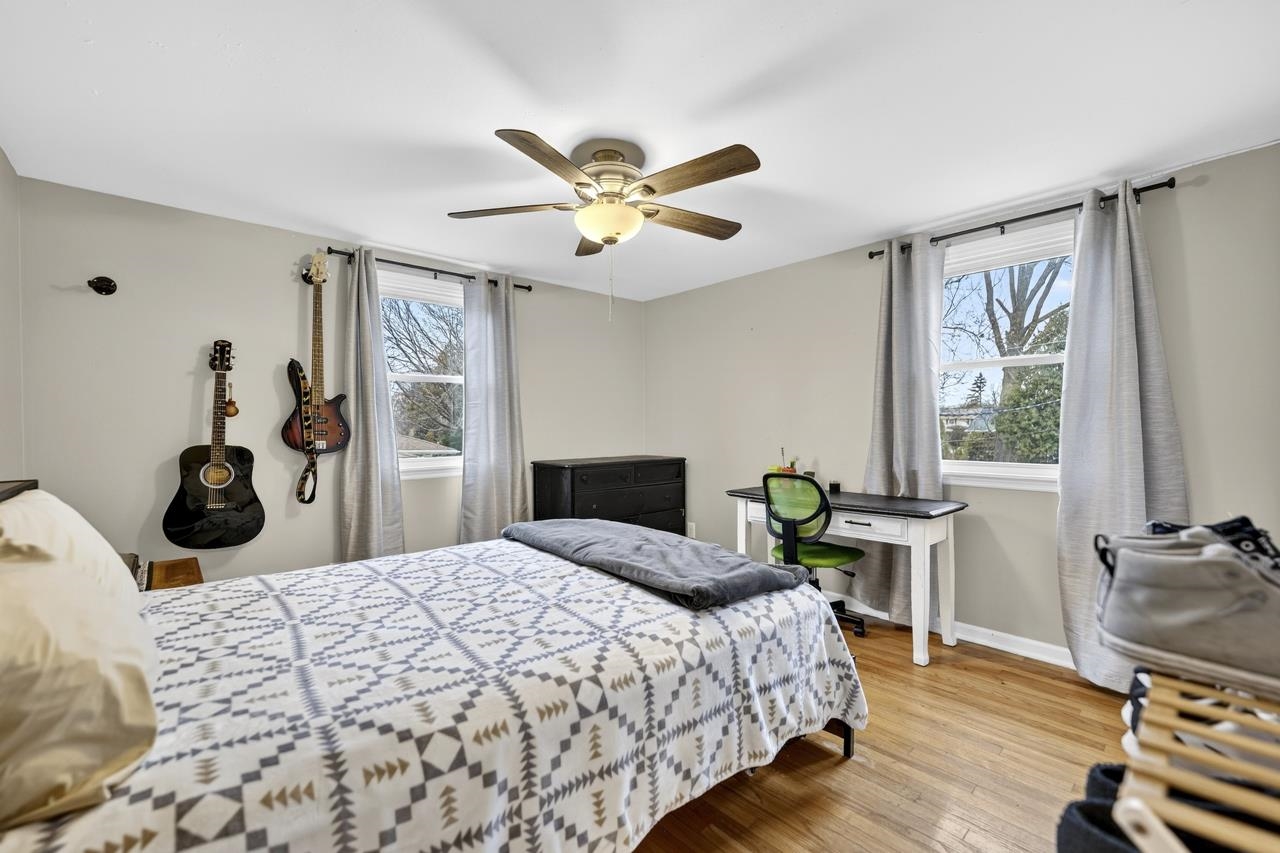 4966 Brigadoon Road Rockford, IL 61107 - Photo 26 of 40 a bedroom with a bed a table and chair with the potted plants