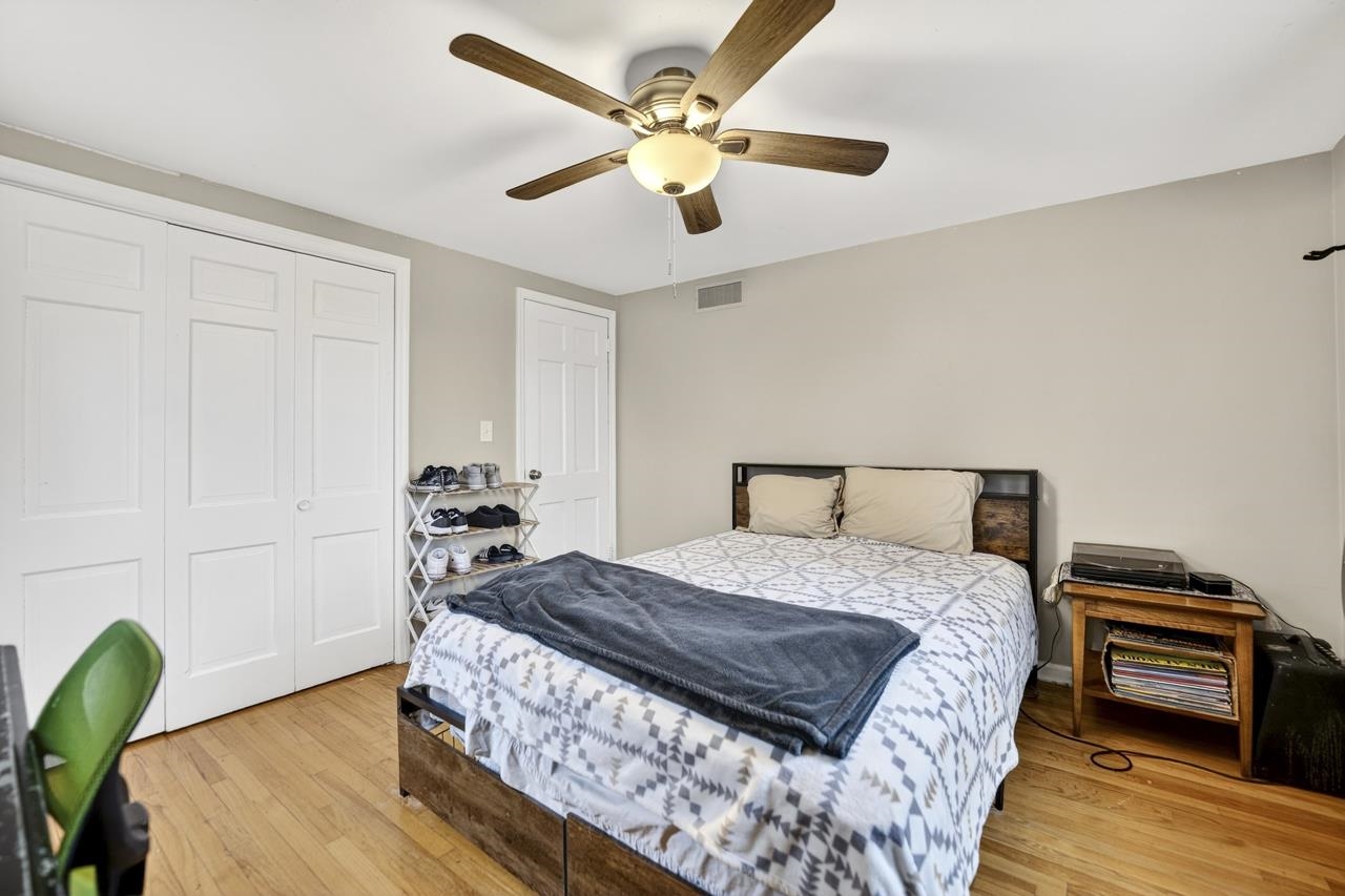 4966 Brigadoon Road Rockford, IL 61107 - Photo 27 of 40 a bedroom with a bed and a chandelier