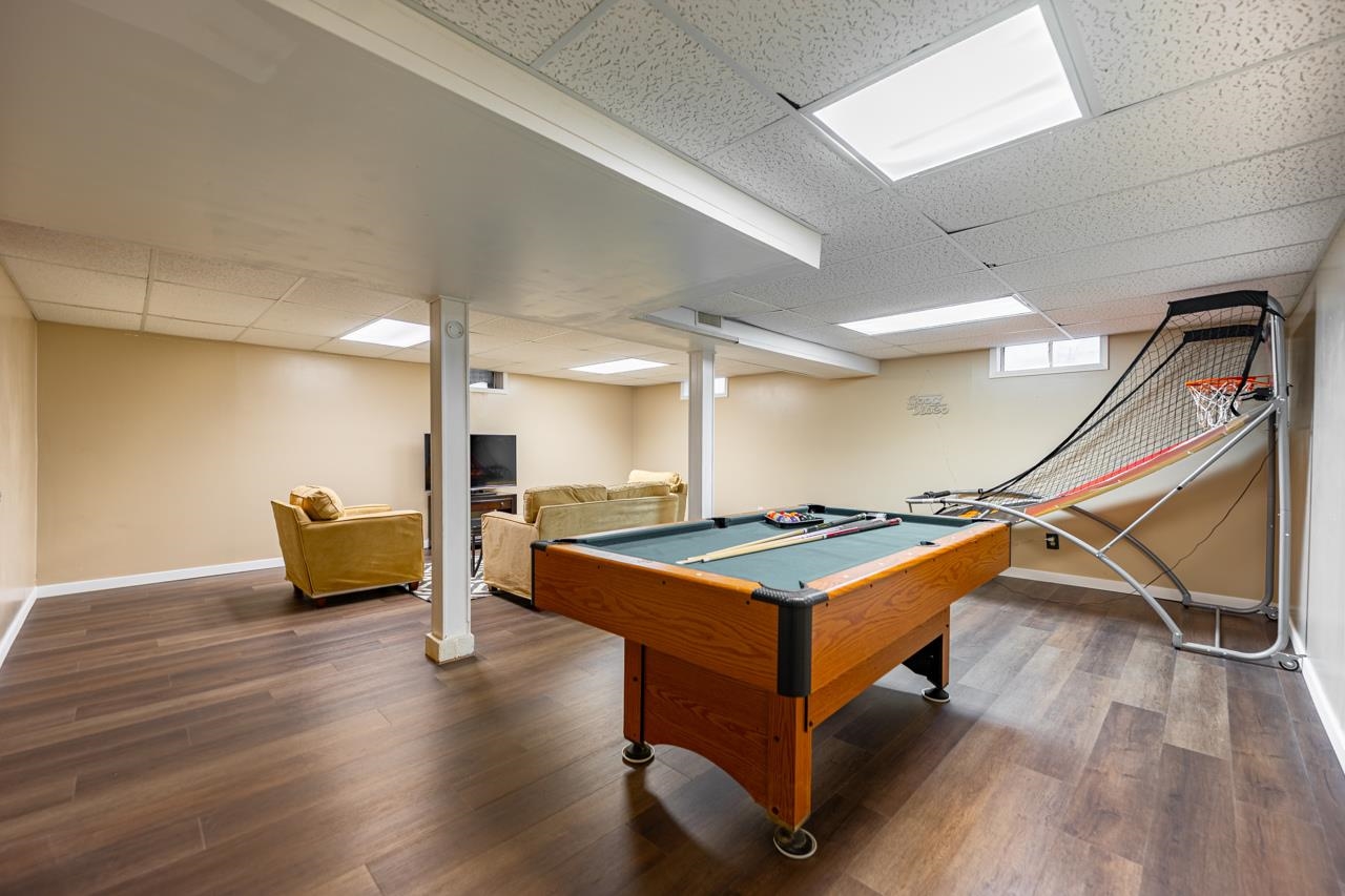 4966 Brigadoon Road Rockford, IL 61107 - Photo 30 of 40 a room with wooden floor pool table and white walls