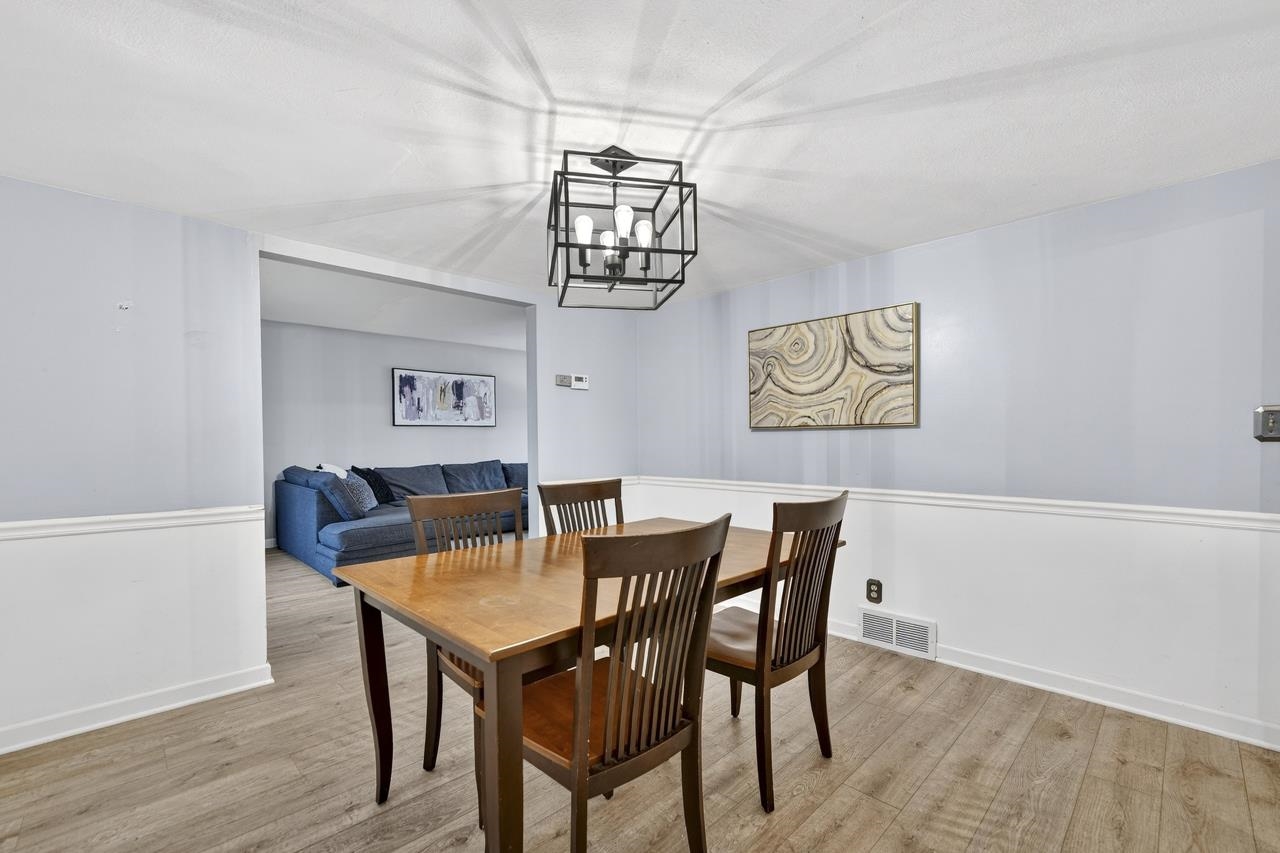 4966 Brigadoon Road Rockford, IL 61107 - Photo 8 of 40 a view of a dining room with furniture and wooden floor