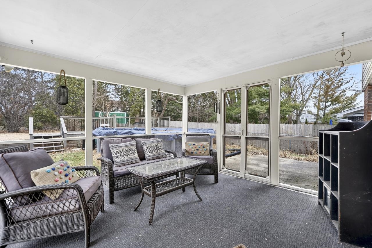 4966 Brigadoon Road Rockford, IL 61107 - Photo 9 of 40 a living room with furniture and a floor to ceiling window