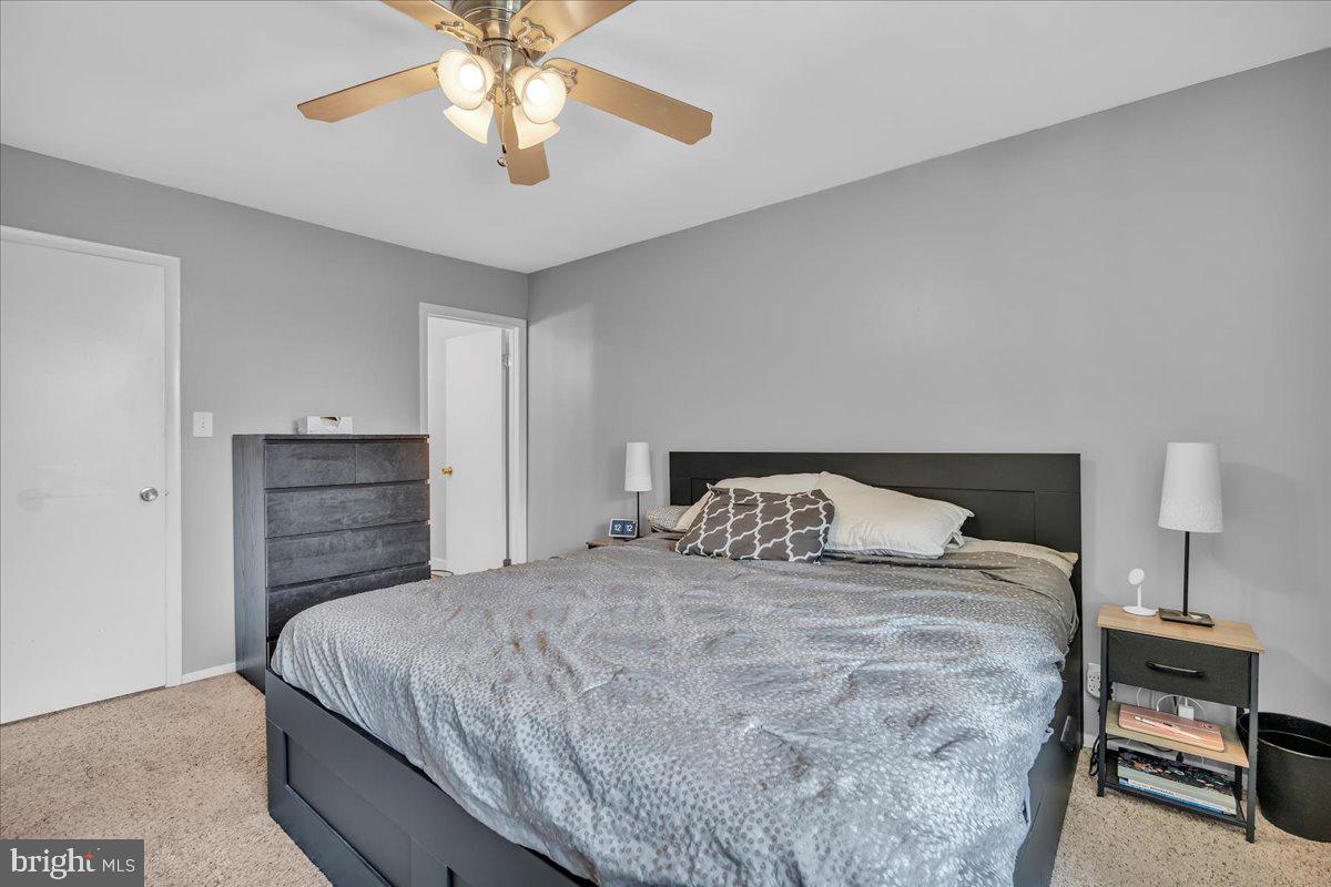 115 East Kings Highway, Unit 334 Maple Shade, NJ 08052 - Photo 13 of 26 a bedroom with a bed and a chandelier