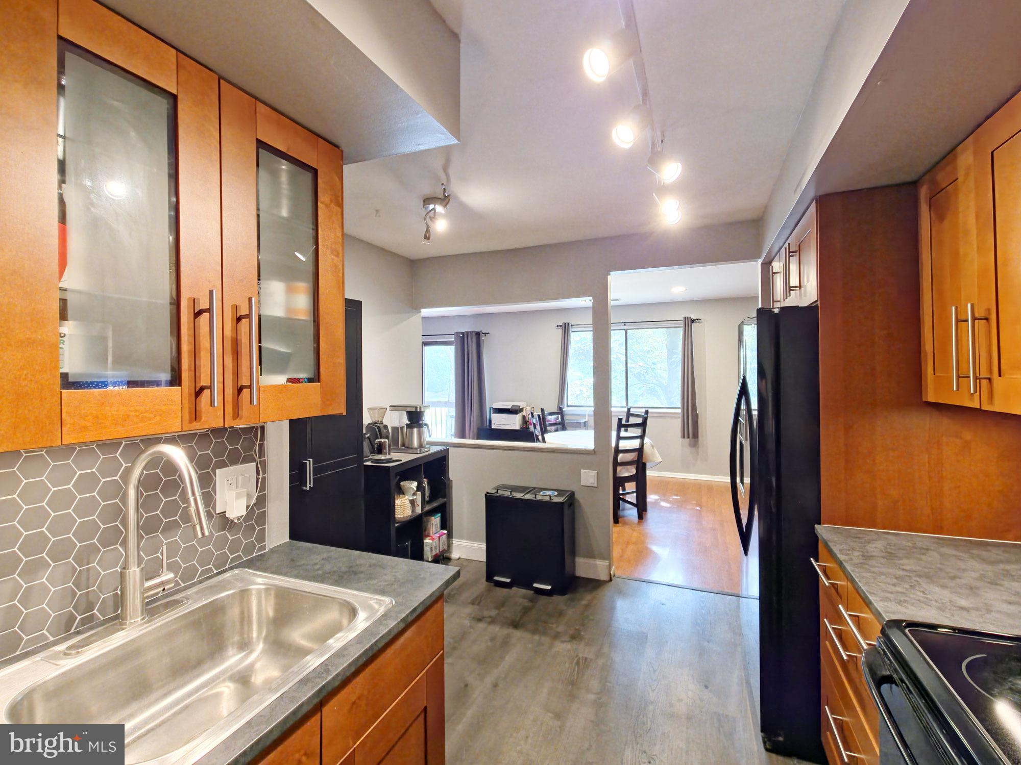 115 East Kings Highway, Unit 334 Maple Shade, NJ 08052 - Photo 2 of 26 a kitchen with stainless steel appliances granite countertop a sink stove and refrigerator
